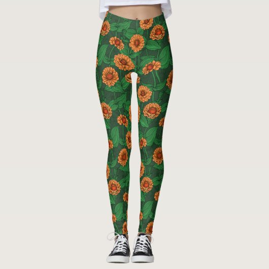 Leggings Fleurs Zinnia orange, feuilles verts sur vert fonc (Devant)