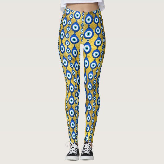 Leggings motif de l'oeil malin sur la texture dorée (Devant)