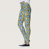 Leggings motif de l'oeil malin sur la texture dorée (Gauche)