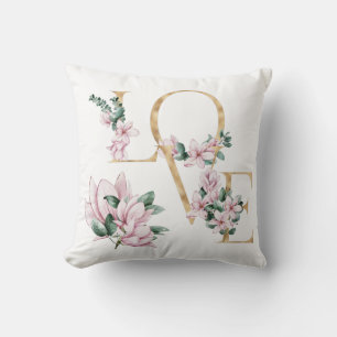 Liefde in gouden letters met magnoliumbloemen kussen