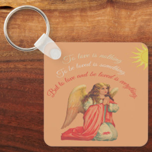 "Liefhebben en bemind worden is alles". Sleutelhanger