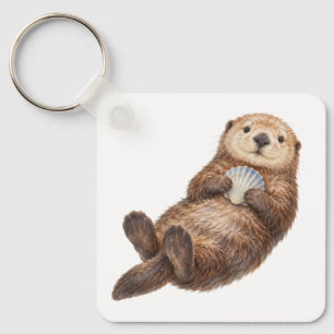Loutre de mer tenant un porte-clés coquillage