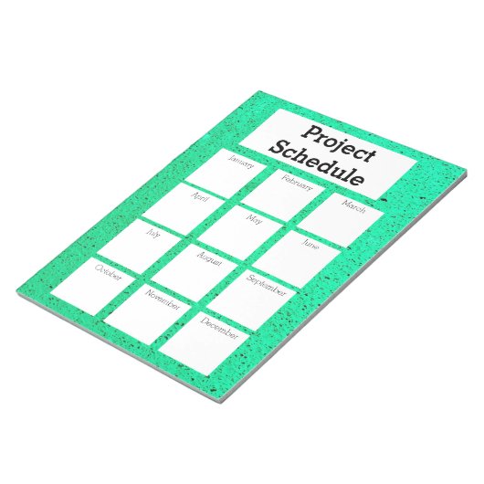 Maandelijks projectschema groene ruwe druk notitieblok (Schuin)