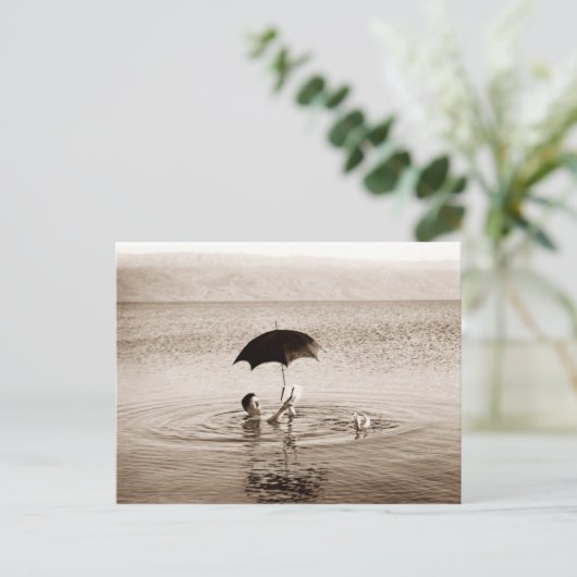 Man lezen onder paraplu in het dode Zee Briefkaart (Staand voorkant)