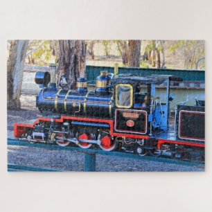 Miniatuur zwart stoomtreinmotor legpuzzel