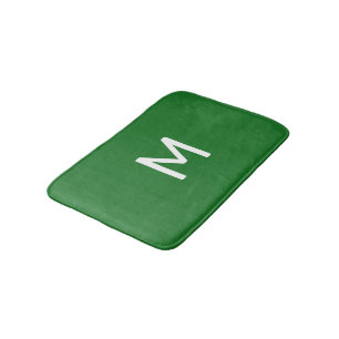 Minimalistisch wit monogram op groen badmat