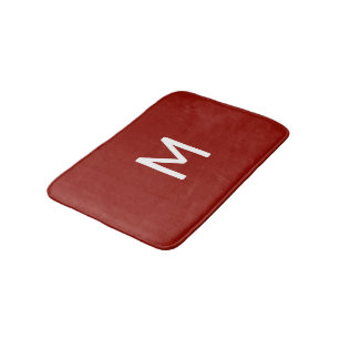 Minimalistisch wit monogram op rood badmat