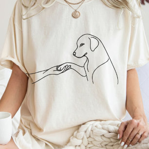 Minimalistische lijntekening van hondenpoot en han t-shirt