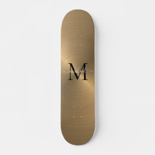 Modern goudborsgeborsteld metaal monogram skateboard