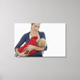 Moeder geeft haar baby. canvas afdruk