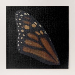 Monarch Butterfly wing on Black Legpuzzel