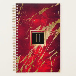 Monogramme or doré en marbre rouge