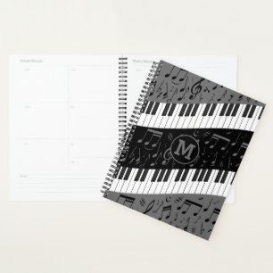 Monogrammen van pianosleutels en muzieknoten planner