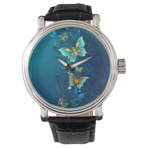 Montre Papillons d'or sur un Arrière - plan bleu