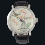 Montre Petits oiseaux perchés sur une branche et sur une<br><div class="desc">Nancy Slocum's a peint de nombreux oiseaux au cours des années. Cette image représente deux petits oiseaux bleus et jaunes perchés sur une branche entourés de fleurs roses et qui ont l'air curieux d'une cage d'oiseaux. Obtenez cette oeuvre d'art ornithologique cool sur votre produit Zazzle dès aujourd'hui.</div>