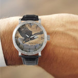 Montre Veille de l'aigle<br><div class="desc">Embrassez la Majesté du temps avec notre Montre d'Aigle. Cette magnifique montre saisit l'essence de la liberté et de l'honneur, avec un aigle majestueux en vol sur fond de ciel doré. C’est un symbole de force et de grâce, un hommage parfait à l’esprit inflexible de la paternité. Avec la date...</div>