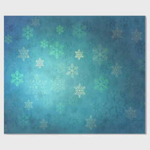 Mooie sneeuwvlokken op de schaduw van blauw-groen cadeaupapier