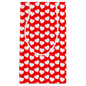 Motif blanc de coeur sur le petit sac rouge de (Devant)
