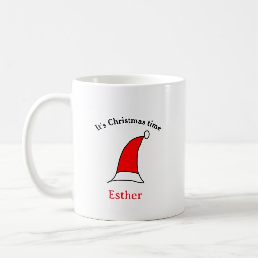 Mug C'est Noël heure Père Noël rouge casquette nom sim (Gauche)
