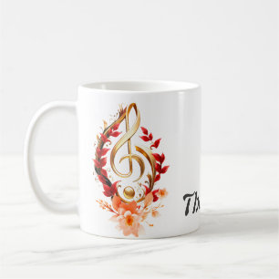 Mug Clé triplée dorée avec feuilles rouges.