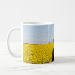 Mug Femme en manteau noir debout sur un terrain d'herb