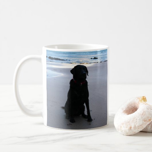 Mug Labrador noir sur une plage (Avec donut)