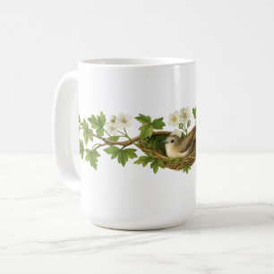 Mug Oiseau dans un nid d'oiseau sur des branches en fl