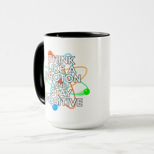 MUG PENSEZ À UN PROTON ET RESTEZ POSITIF (Devant gauche)