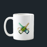 Mug Toasting with a bottle<br><div class="desc">"Toasting with a bottle" features a striking design of crossed champagne bottles and the word "Cheers, " creating a celebratory mood. It's the perfect item to add color to special moments such as parties,  anniversaries,  and the New Year holidays. It creates a glamorous and fun atmosphere.</div>