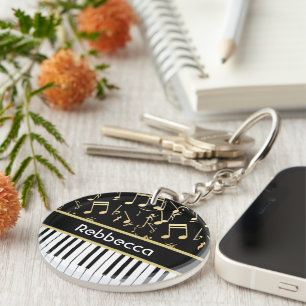 Muzieknoten en pianoketoetsen, zwart en goud sleutelhanger