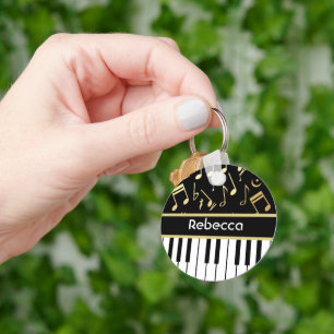 Muzieknoten en pianoketoetsen, zwart en goud sleutelhanger