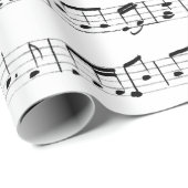 Muzieknoten over wit cadeaupapier (Rol Hoek)