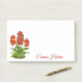 Notes post-it de la fleur orange rouge orchidée (Sur un bureau)