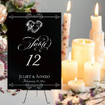 Numéro De Table Calligraphy & Silver Heart - Black Table Number<br><div class="desc">The design features an elegant black background embellished with scroll borders, a heart and placeholders for the table number, couple's names and date of event. Available in several colors for your wedding theme. (Glitter is simulated in the artwork). Designed to coordinate with the Romantic Scroll Hearts & Calligraphy Wedding Collection....</div>