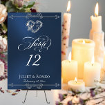 Numéro De Table Calligraphy & Silver Heart - Blue Table Number<br><div class="desc">The design features an elegant blue background embellished with scroll borders, a heart and placeholders for the table number, couple's names and date of event. Available in several colors for your wedding theme. (Glitter is simulated in the artwork). Designed to coordinate with the Romantic Scroll Hearts & Calligraphy Wedding Collection....</div>