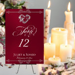 Numéro De Table Calligraphy & Silver Heart - Burgundy Table Number<br><div class="desc">The design features an elegant burgundy background embellished with scroll borders, a heart and placeholders for the table number, couple's names and date of event. Available in several colors for your wedding theme. Designed to coordinate with the Romantic Scroll Hearts & Calligraphy Wedding Collection. To change details, click «Personalize». To...</div>