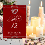 Numéro De Table Calligraphy & Silver Heart - Red Table Number<br><div class="desc">The design features an elegant crimson red background embellished with scroll borders, a heart and placeholders for the table number, couple's names and date of event. Available in several colors for your wedding theme. (Glitter is simulated in the artwork). Designed to coordinate with the Romantic Scroll Hearts & Calligraphy Wedding...</div>