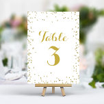 Numéro De Table Faux Gold Parties scintillant Foil Elégant Confett<br><div class="desc">Ajoutez une touche de brillance et de sophistication à votre réception de mariage avec ces élégants numéros de table. Dotées d'une délicate diffusion de confettis de parties scintillant en faux or sur un arrière - plan blanc immaculé, ces cartes créent un look moderne et chic. Personnalisez facilement vos numéros de...</div>