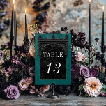 Numéro De Table Gothic Black Raven & Black Arch Teal Wedding<br><div class="desc">Transport your guests to a world of dark, enchanting elegance with our vintage gothic wedding table number card. The deep, aged teal green background sets the stage for a striking contrast, as bold white text emerges from intricate black text boxes. At the pinnacle of this invitation, a three-dimensional gothic border...</div>