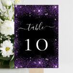 Numéro De Table Mariage brillant parties scintillant violet noir<br><div class="desc">Un arrière - plan noir décoré de faux brillants violets. Texte blanc. Personnalisez et ajoutez vos numéros de table. Ajoutez vos numéros un par un.</div>