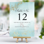 Numéro De Table Moderne Luxe Gold Flecks Turquoise Mist Mariage<br><div class="desc">Elevez votre réception de mariage avec ces numéros de table sophistiqués. Le design moderne présente une turquoise aquarelle rêvée, agrémentée de luxueuses taches d'or, créant un effet subtil mais frappant. Ces cartes personnalisables allient le style contemporain et une touche d'opulence, ce qui en fait l'ajout parfait à votre journée spéciale....</div>