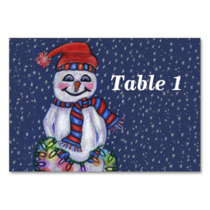 Numéro De Table Snowman souriant tenant une chaîne des lumières de