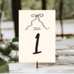 Numéro De Table Whimsical Quirky manuscrit Bow<br><div class="desc">Numéro de la table de douche à marée blanc avec un bel arc dessiné à la main dans un style amusant et ludique, accompagné d'une police décontractée manuscrite qui saisit parfaitement l'excitation et la joie de l'occasion. Le signe d'accueil est offert dans une palette de couleurs neutres de gris foncé...</div>