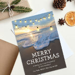 Ocean Beach Carte de Noël<br><div class="desc">Cartes de Noël de destination de plage avec une côte côtière,  un coucher de soleil magnifique,  des lampes à cordes,  le dicton "joyeux noël",  un message de vacances mignon,  et vos noms.</div>