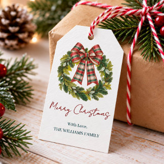 Op maat gemaakte kerstkrans met plaid strik en fam cadeaulabel