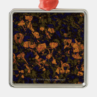 Oranje bloem tegen bladcamouflagepatroon metalen ornament