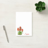 Oranje rode orchidee bloem na het opschrift post-it® notes (Kantoor)
