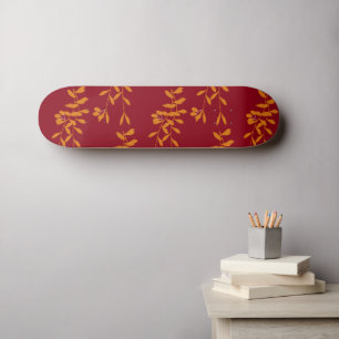 Oranje silhouetbladeren op rood skateboard
