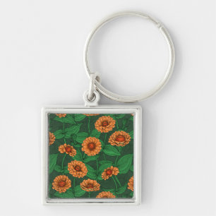 Oranje Zinnia bloemen, groene bladeren op donkergr Sleutelhanger