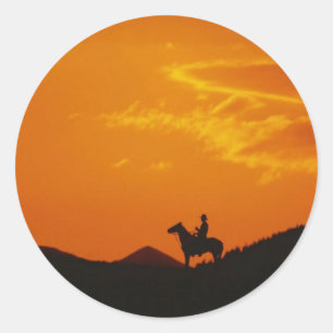 Oranje zonsondergang met Cowboy Silhouette Ronde Sticker